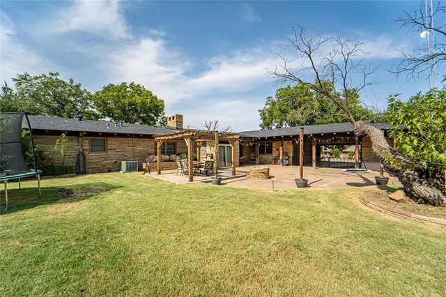 a front view of a house with garden and patio