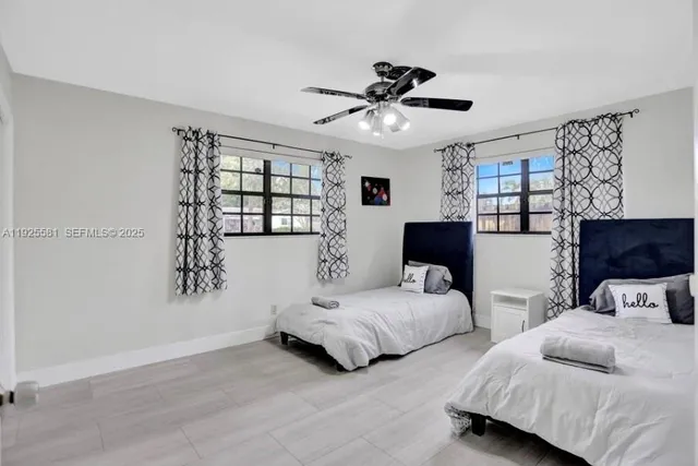 a bedroom with two beds and a chandelier