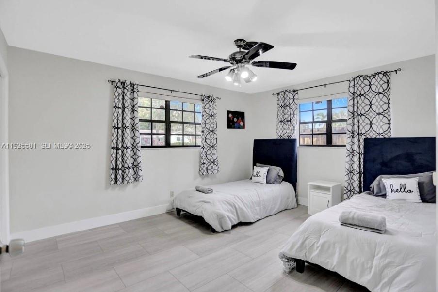 5500 Buchanan Street Hollywood, FL 33021 - Photo 12 of 24 a bedroom with two beds and a chandelier