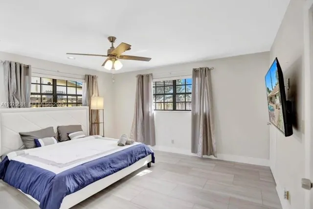 a spacious bedroom with a bed and a chandelier