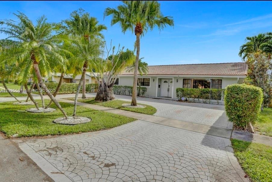 5500 Buchanan Street Hollywood, FL 33021 - Photo 4 of 24 a front view of a house with garden