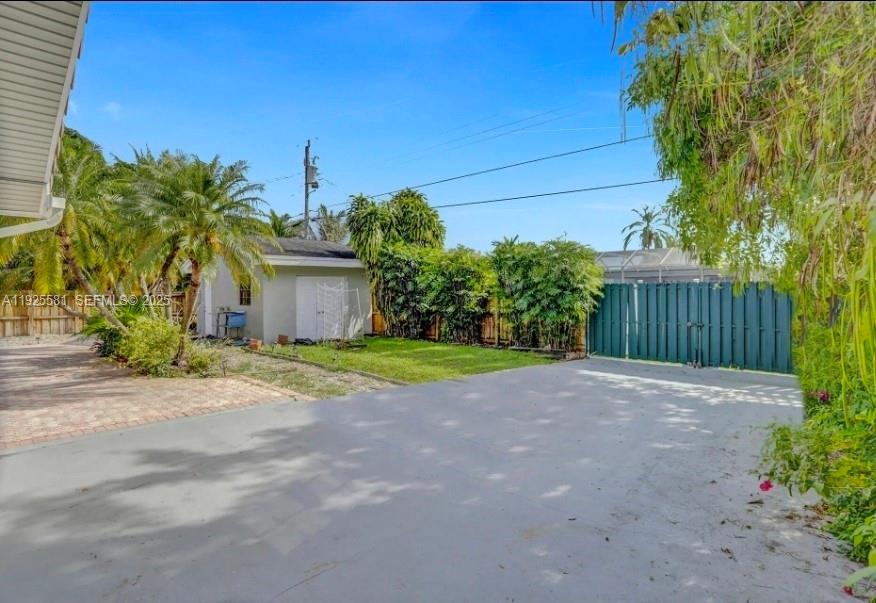 5500 Buchanan Street Hollywood, FL 33021 - Photo 5 of 24 a view of a house with a small yard and wooden fence