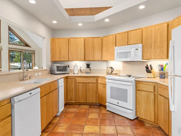 a kitchen with stainless steel appliances granite countertop a sink and cabinets