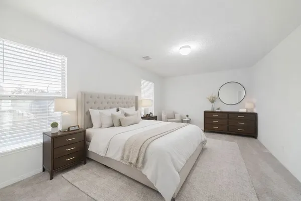 a bedroom with a bed and a dresser