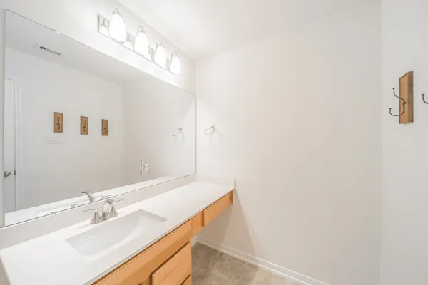 a bathroom with a sink a vanity and a mirror