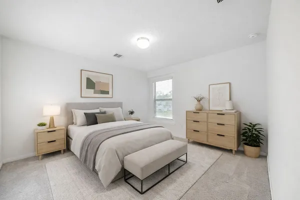 a bedroom with a bed and a dresser