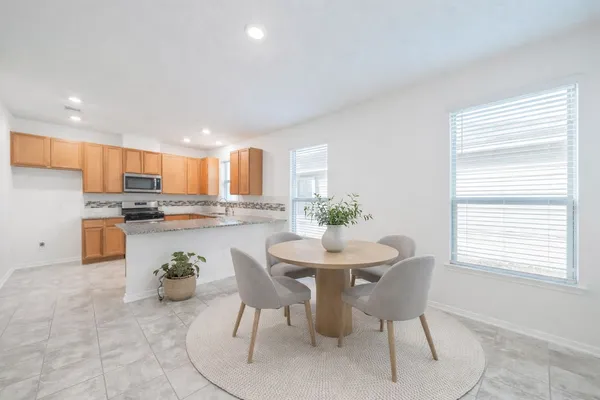a kitchen with a table and chairs in it