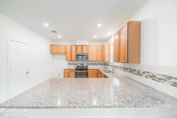 a kitchen with a sink a counter top space and cabinets