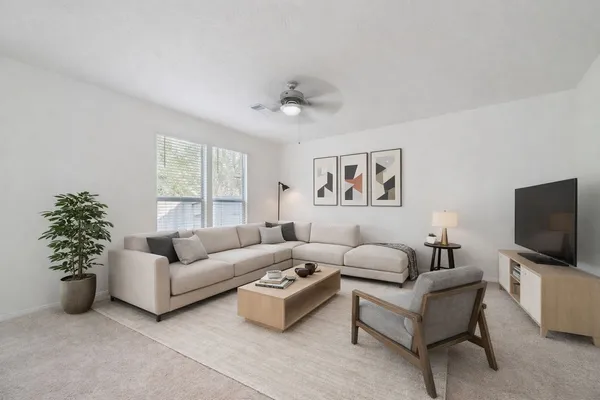 a living room with furniture and a flat screen tv