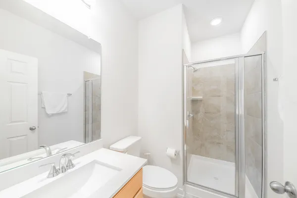 a bathroom with a sink toilet and shower