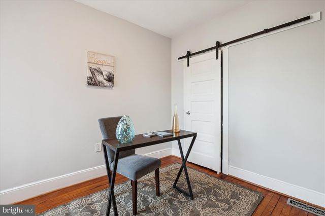 a view of a workspace room with wooden floor