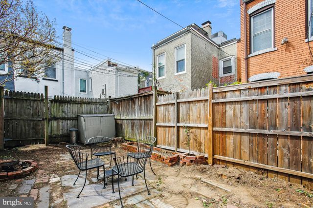 a view of a chair and table in the balcony