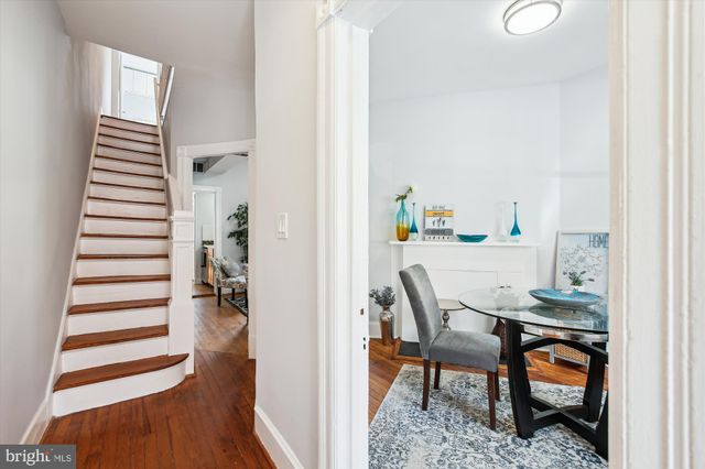 a dining room with furniture and wooden floor