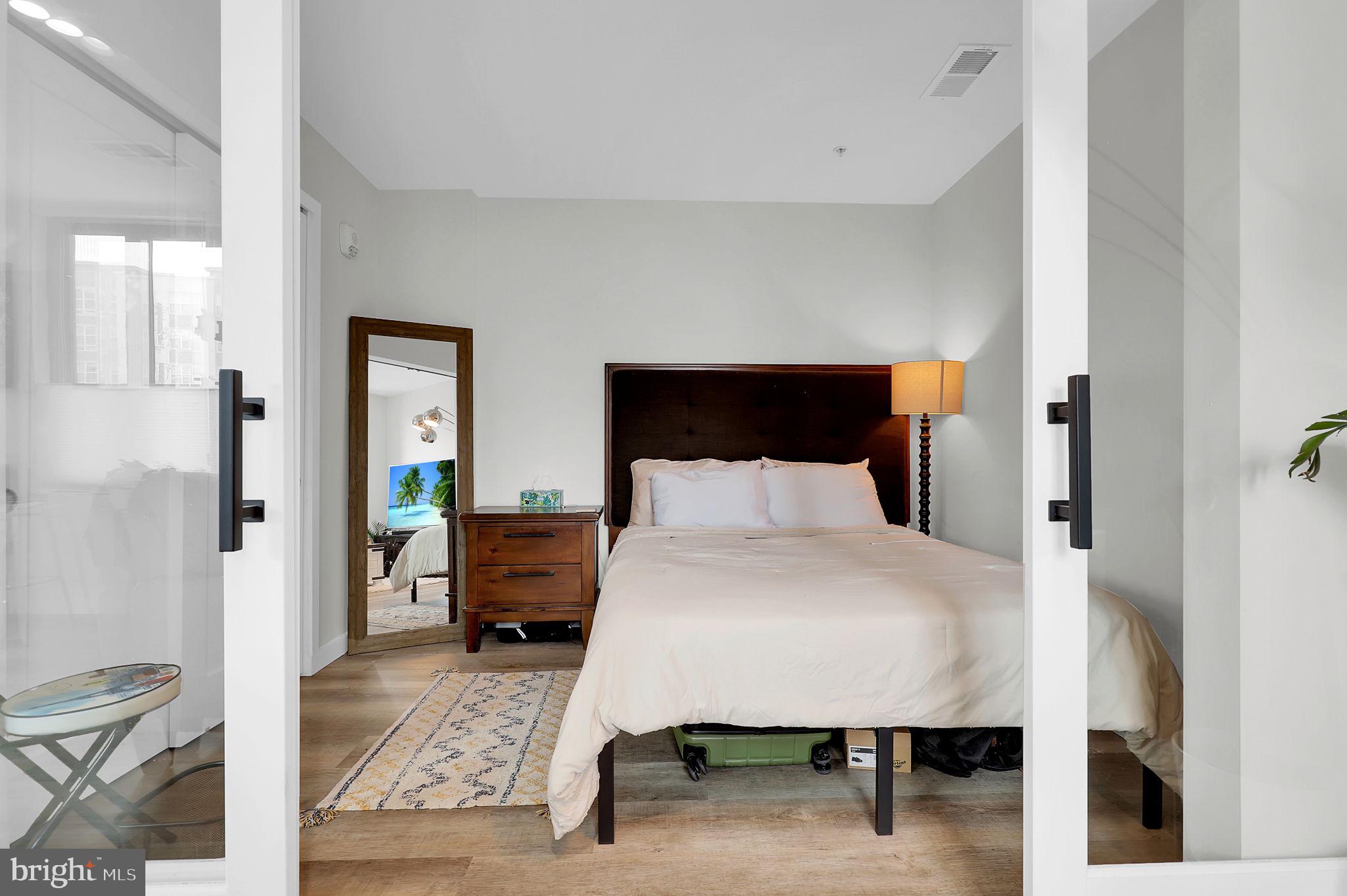 700 Roeder Road, Unit 101 Silver Spring, MD 20910 - Photo 8 of 16 a bedroom with a bed and a table