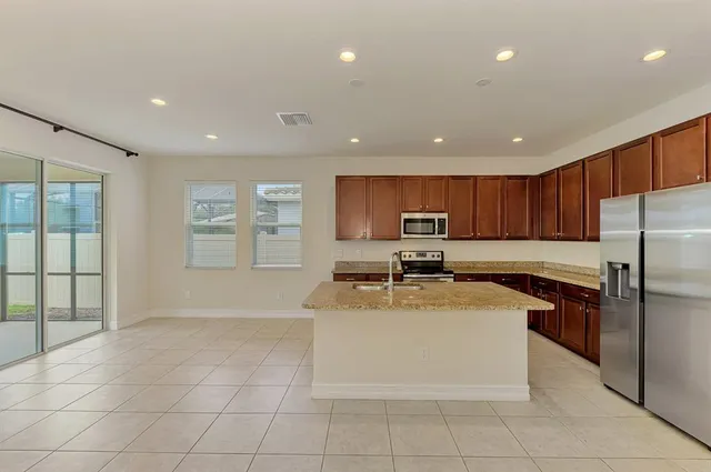 a large kitchen with cabinets and stainless steel appliances