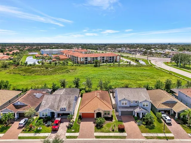 an aerial view of a house with garden space and ocean view