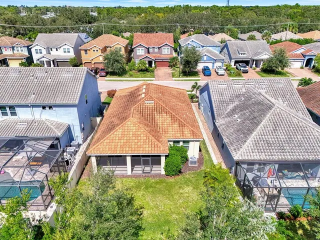 an aerial view of multiple houses with a yard