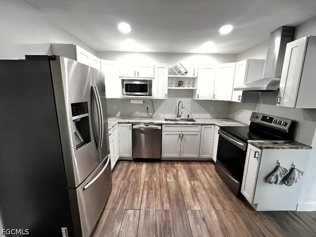 144 Whidden Road North Fort Myers, FL 33917 - Photo 4 of 16 a kitchen with stainless steel appliances a refrigerator stove microwave and sink