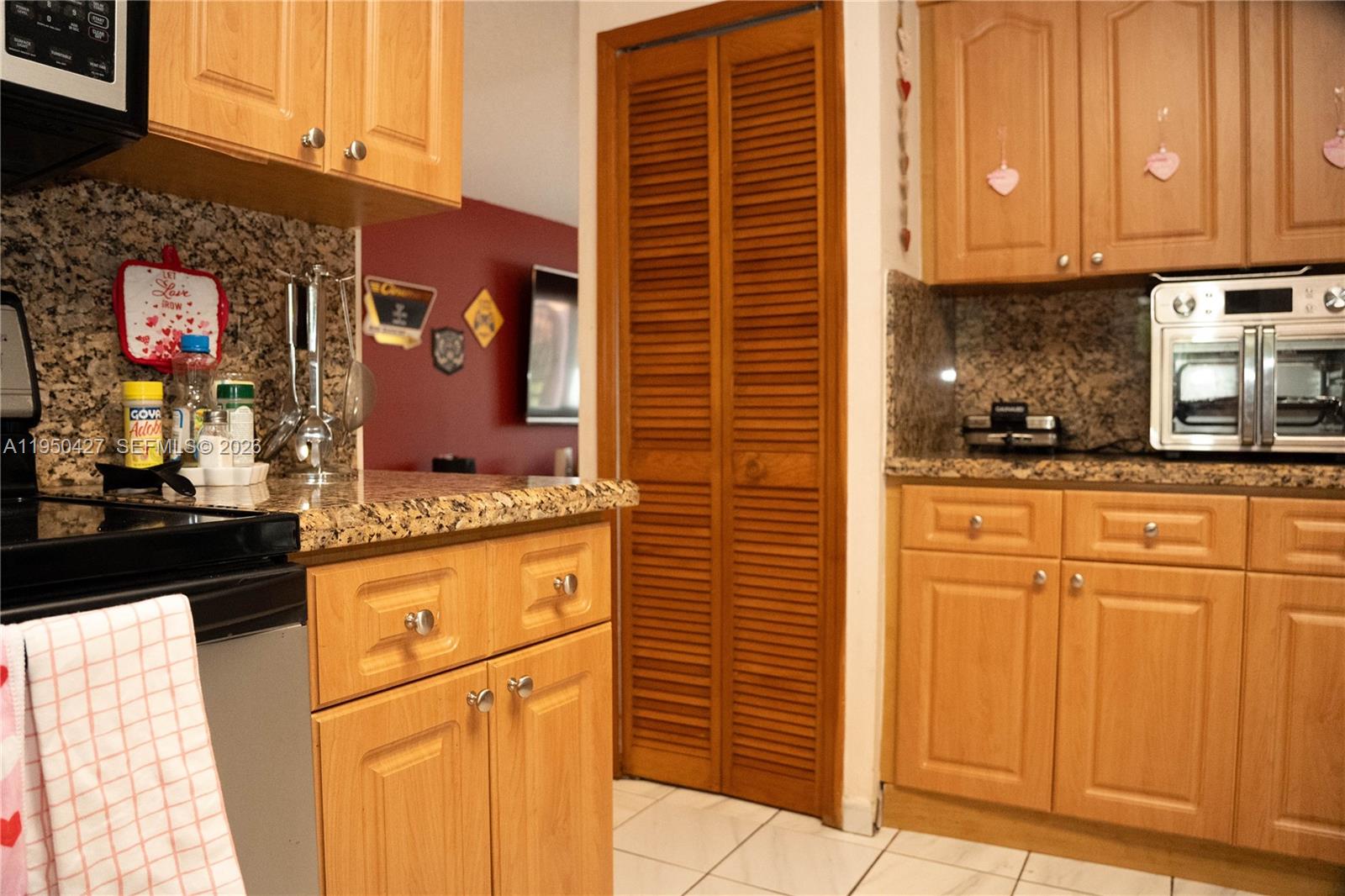 3700 Southwest 139th Avenue Miami, FL 33175 - Photo 14 of 40 a kitchen with stainless steel appliances granite countertop a stove a sink and a refrigerator
