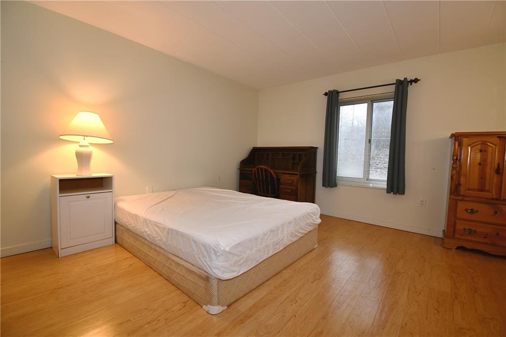 5 Bayard Road, Unit 100 Pittsburgh, PA 15213 - Photo 12 of 30 a bedroom with a bed and a night stand