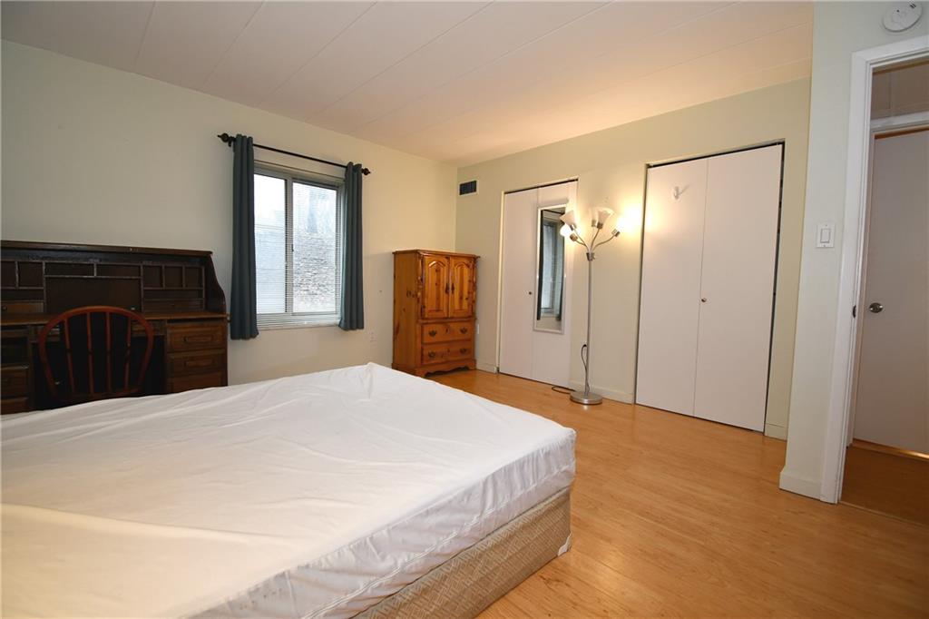 5 Bayard Road, Unit 100 Pittsburgh, PA 15213 - Photo 13 of 30 a spacious bedroom with a bed and a dresser