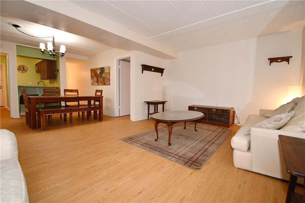 5 Bayard Road, Unit 100 Pittsburgh, PA 15213 - Photo 7 of 30 a living room with furniture and a dining table with kitchen view