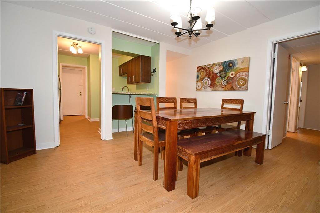 5 Bayard Road, Unit 100 Pittsburgh, PA 15213 - Photo 8 of 30 a living room with furniture a desk and a chandelier