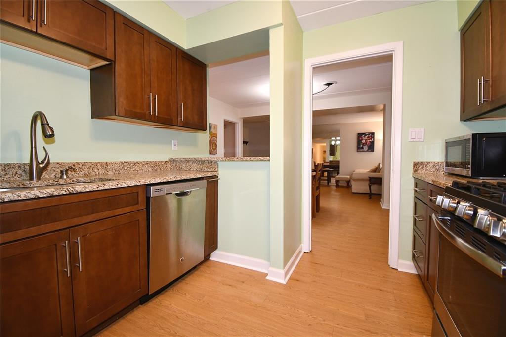5 Bayard Road, Unit 100 Pittsburgh, PA 15213 - Photo 10 of 30 a kitchen with stainless steel appliances granite countertop a sink stove and cabinets