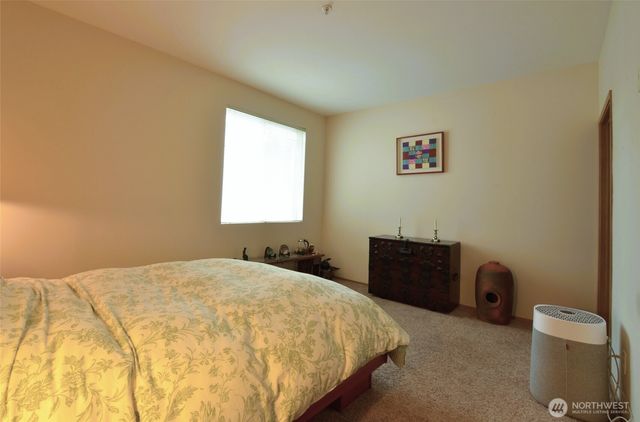 a bedroom with a bed and a dresser