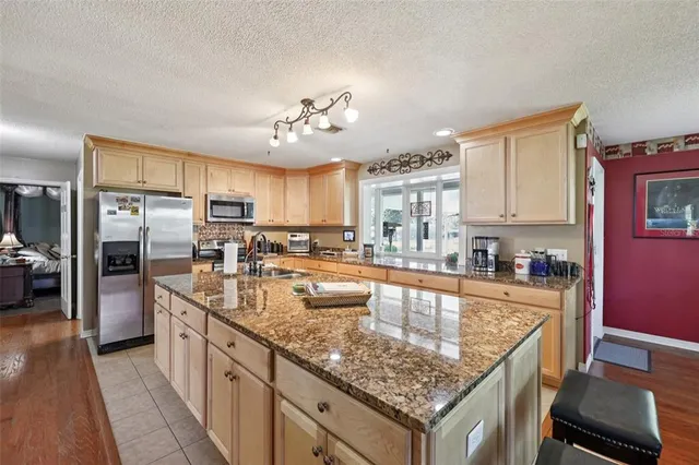 a kitchen with granite countertop a sink and stove