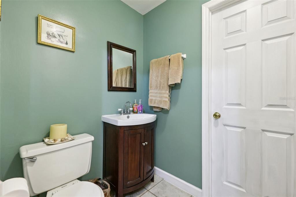 1105 South 9th Street Leesburg, FL 34748 - Photo 21 of 69 a bathroom with a toilet sink and mirror