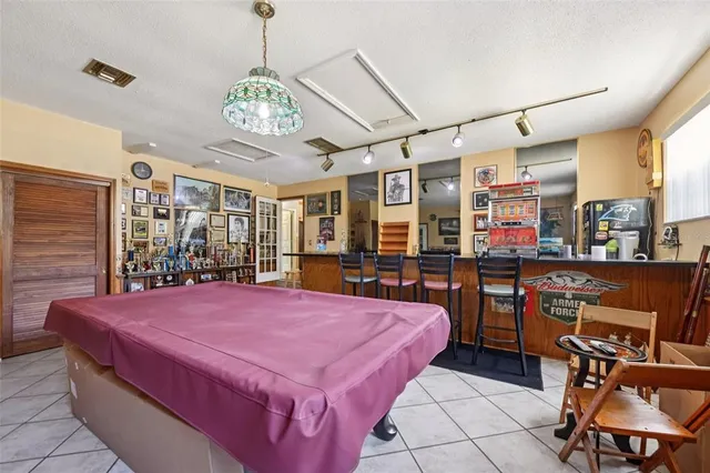 a bedroom with a bed couch and a fireplace