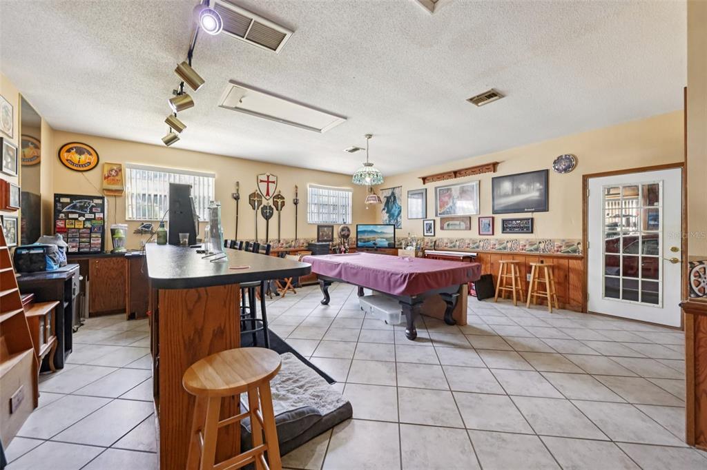 1105 South 9th Street Leesburg, FL 34748 - Photo 24 of 69 a living room with couches a dining table and chairs with kitchen view