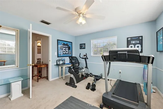 a view of a chairs and table in patio with a swimming pool