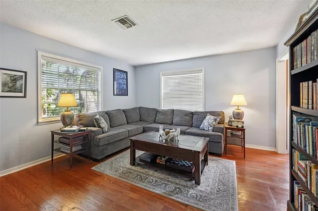 a living room with furniture and a book shelf
