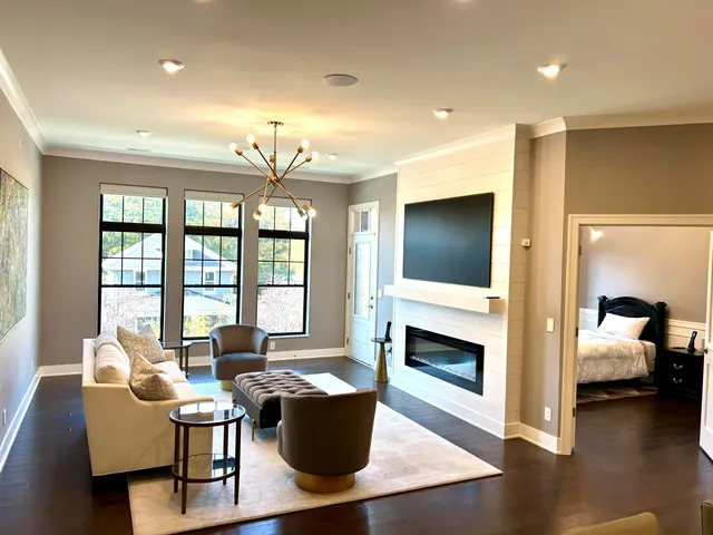 a kitchen with stainless steel appliances a table chairs refrigerator and cabinets