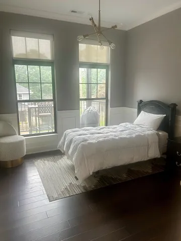 a bedroom with a large bed and a large window
