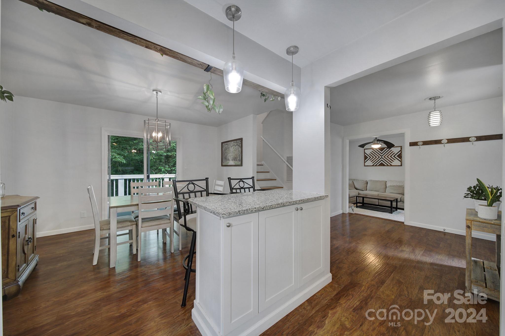 6027 Windjammer Drive Tega Cay, SC 29708 - Photo 12 of 27 a kitchen with stainless steel appliances granite countertop a sink stove and wooden floor