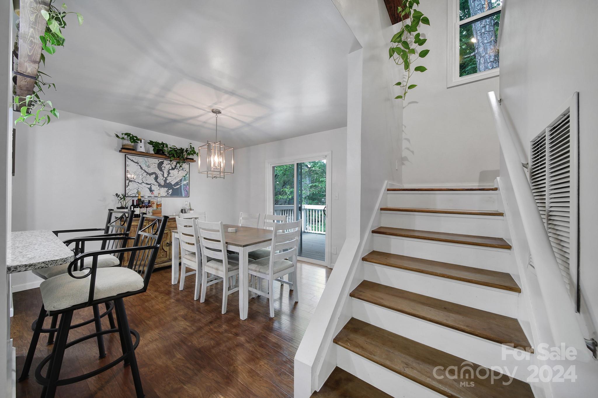 6027 Windjammer Drive Tega Cay, SC 29708 - Photo 13 of 27 a view of a dining room with furniture window and wooden floor