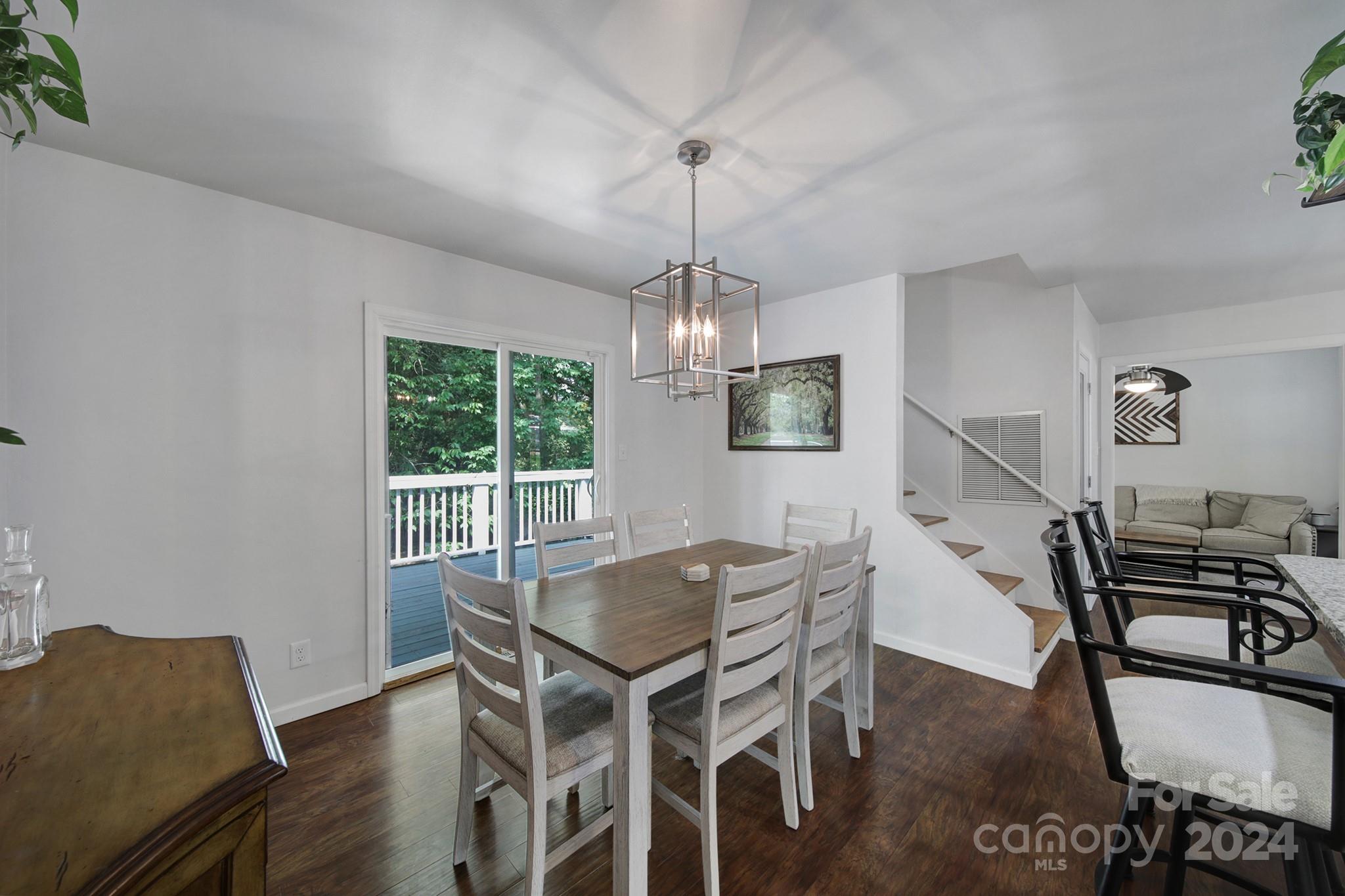 6027 Windjammer Drive Tega Cay, SC 29708 - Photo 14 of 27 a view of a dining room with furniture window and wooden floor