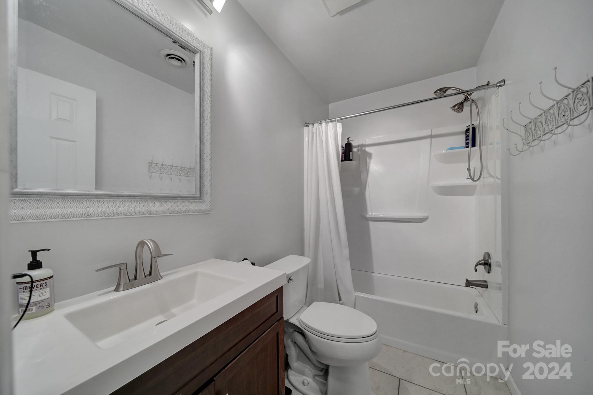 6027 Windjammer Drive Tega Cay, SC 29708 - Photo 17 of 27 a bathroom with a sink toilet and shower