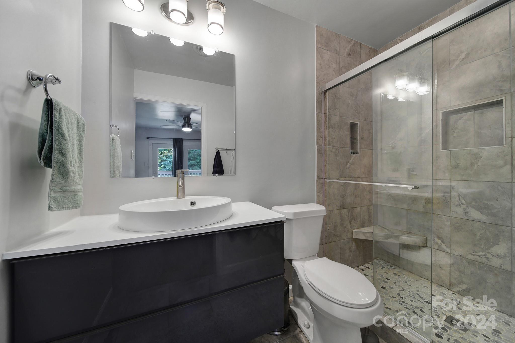 6027 Windjammer Drive Tega Cay, SC 29708 - Photo 20 of 27 a bathroom with a sink toilet and shower