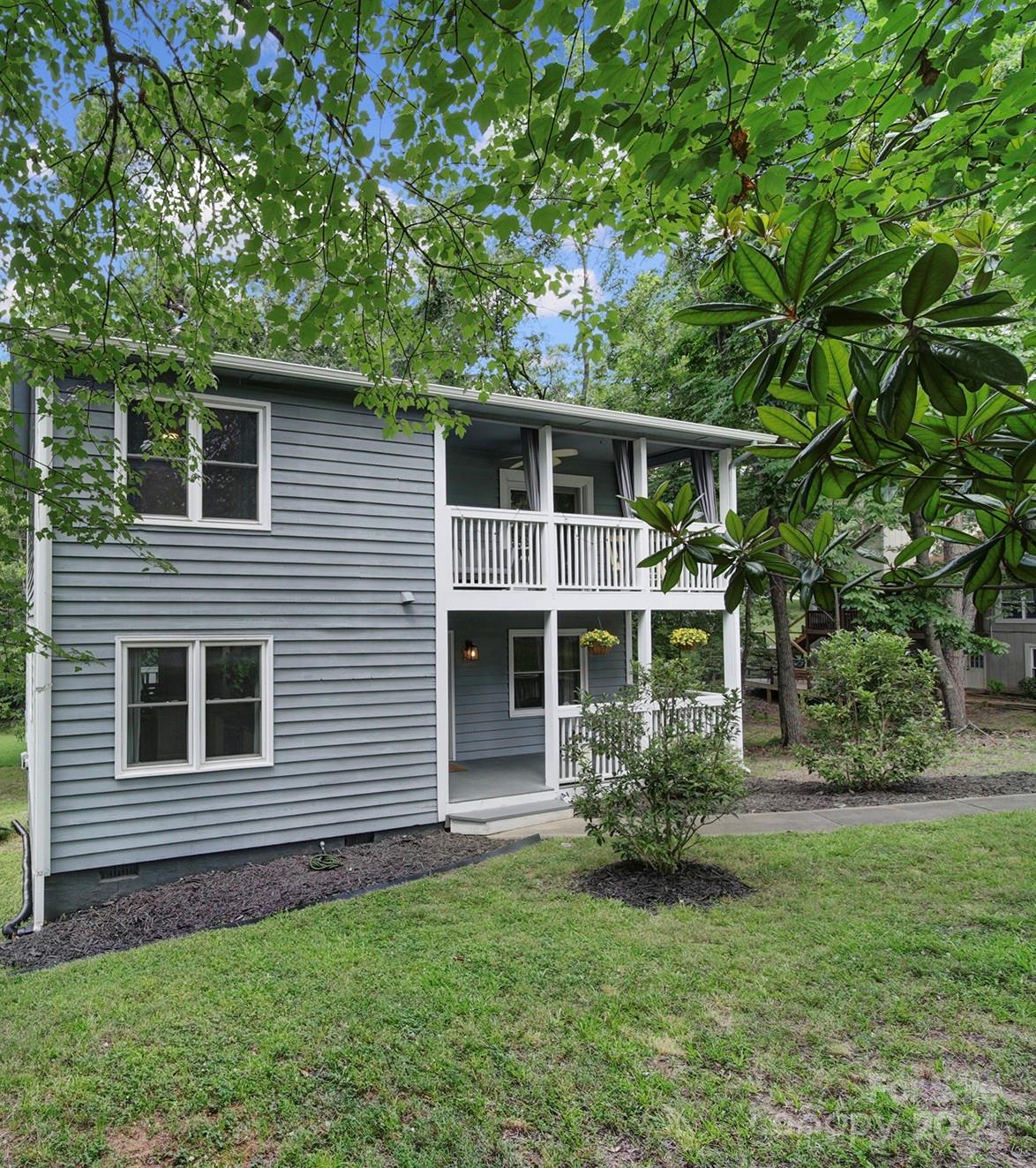 6027 Windjammer Drive Tega Cay, SC 29708 - Photo 2 of 27 a front view of a house with a garden