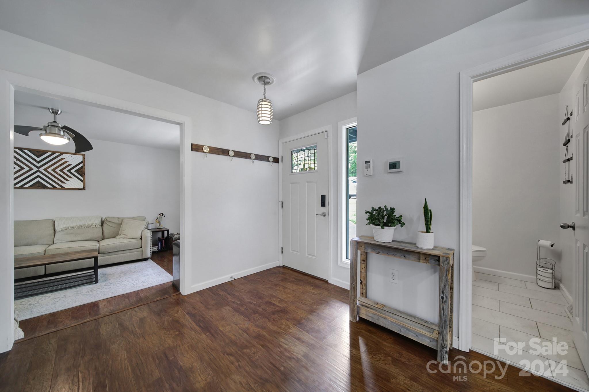 6027 Windjammer Drive Tega Cay, SC 29708 - Photo 5 of 27 a living room with furniture and wooden floor