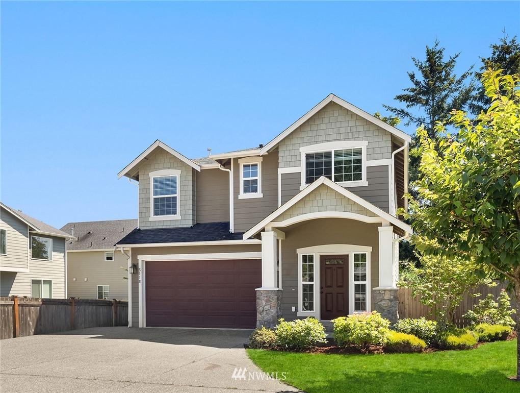 5115 Northeast 6th Place Renton, WA 98059 - Photo 2 of 26 a front view of a house with garden