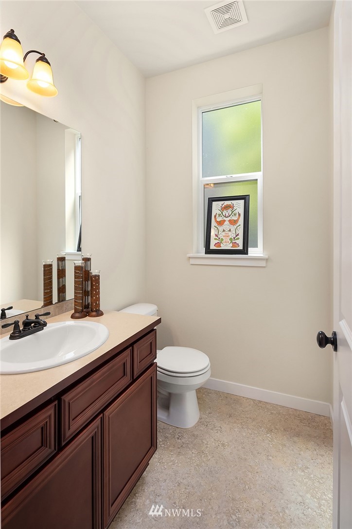 5115 Northeast 6th Place Renton, WA 98059 - Photo 13 of 26 a bathroom with a granite countertop toilet sink and mirror