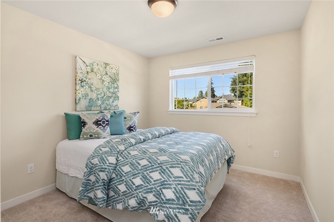 5115 Northeast 6th Place Renton, WA 98059 - Photo 14 of 26 a bedroom with a bed and a window