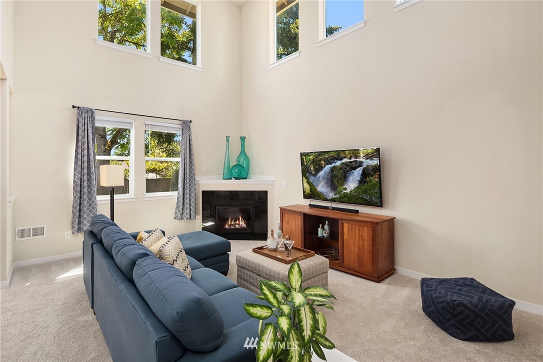 5115 Northeast 6th Place Renton, WA 98059 - Photo 6 of 26 a living room with furniture and a fireplace