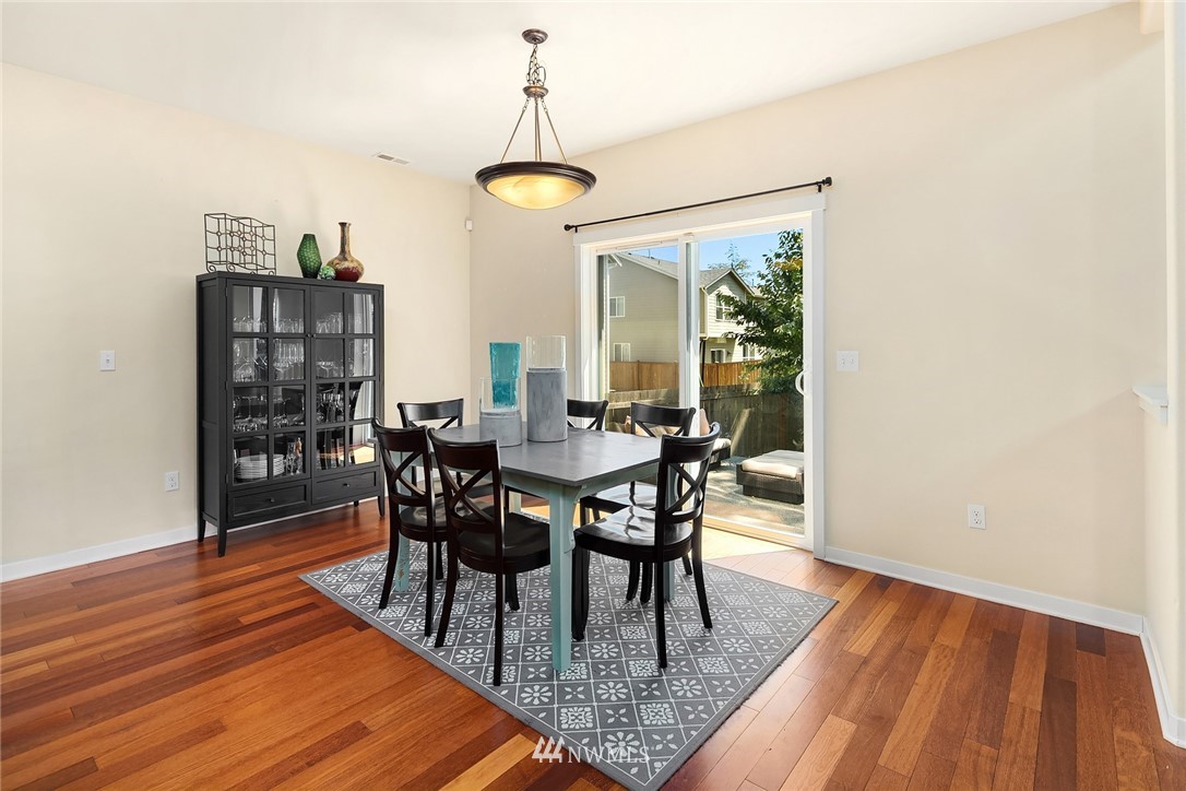 5115 Northeast 6th Place Renton, WA 98059 - Photo 10 of 26 a dining room with furniture a chandelier and wooden floor