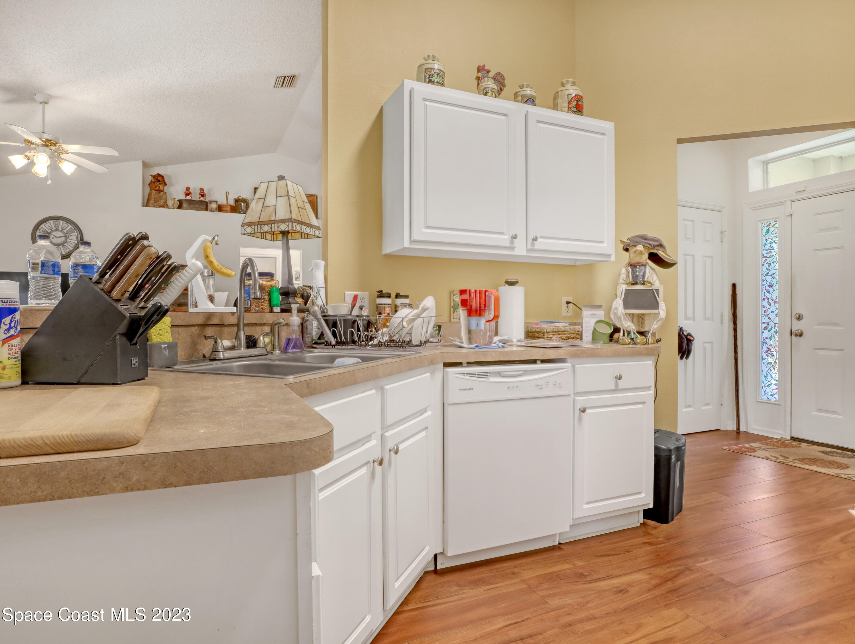 1550 Reed Street Northwest Palm Bay, FL 32907 - Photo 11 of 33 a kitchen with cabinets a sink and appliances
